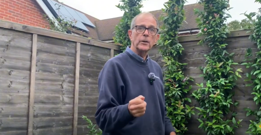 Ken Crowther near some fruit trees.